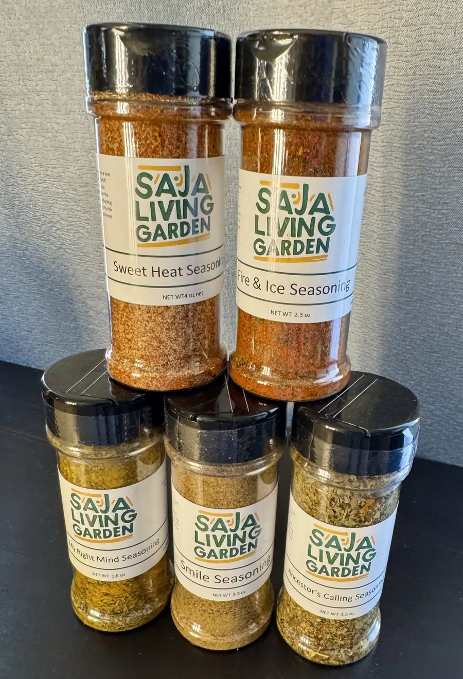 Five jars of Saja Living Garden seasoning blends stacked together